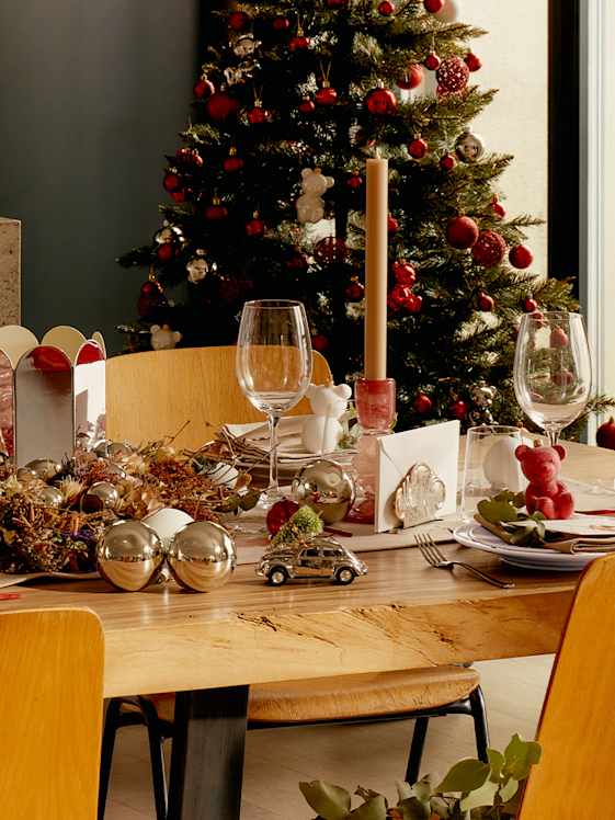 Festive table setting with Christmas decorations and tree